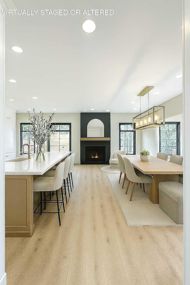 1103 Centennial Dr, Chattanooga, TN 37405 - dining room featuring healthy amount of natural light, recessed lighting, light wood-style flooring, and a warm lit fireplace