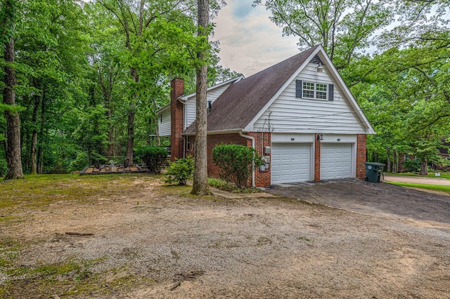 848 Skyline Park Dr, Signal Mountain, TN 37377 - view of property exterior with brick siding, a chimney, driveway, and a garage