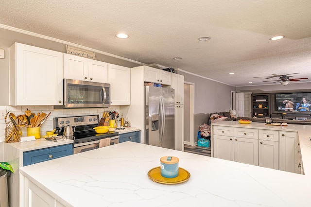 848 Skyline Park Dr, Signal Mountain, TN 37377 - kitchen with stainless steel appliances, crown molding, white cabinetry, backsplash, and light stone counters