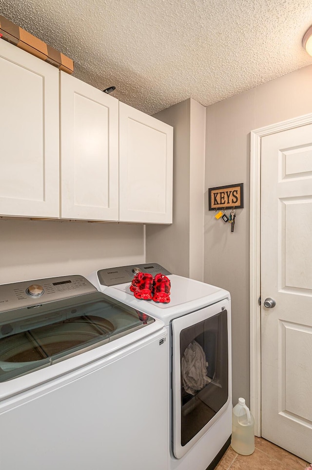 848 Skyline Park Dr, Signal Mountain, TN 37377 - laundry area with washer and clothes dryer, cabinet space, and a textured ceiling