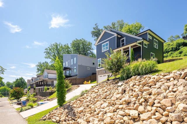 834 Dartmouth St, Chattanooga, TN 37405 - view of side of home featuring board and batten siding, an attached garage, driveway, and a residential view