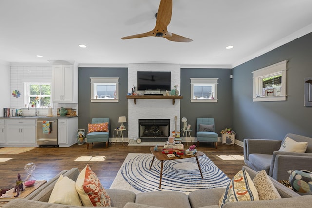 834 Dartmouth St, Chattanooga, TN 37405 - living area with a ceiling fan, crown molding, a stone fireplace, recessed lighting, and wood finished floors