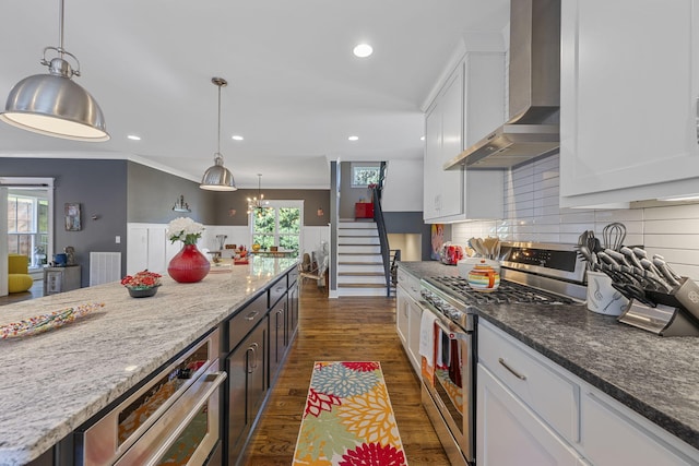 834 Dartmouth St, Chattanooga, TN 37405 - kitchen featuring gas stove, wall chimney exhaust hood, white cabinetry, dark wood-style flooring, and tasteful backsplash