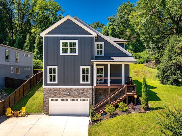834 Dartmouth St, Chattanooga, TN 37405 - view of front of home with stairs, board and batten siding, concrete driveway, an attached garage, and a porch
