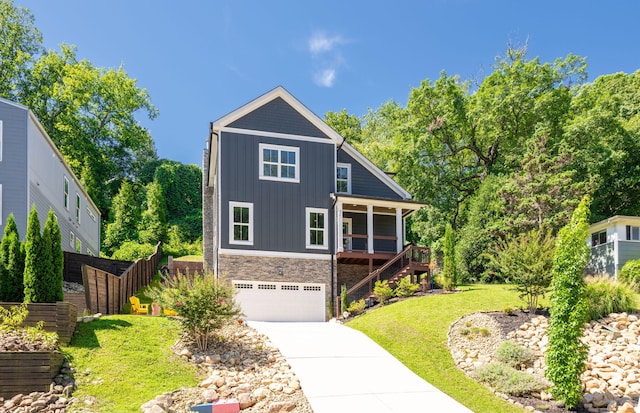 834 Dartmouth St, Chattanooga, TN 37405 - view of front of home with board and batten siding, stairway, stone siding, a garage, and concrete driveway