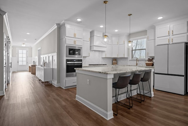 596 Nature Trl, Soddy Daisy, TN 37379 - kitchen with stainless steel appliances, premium range hood, white cabinetry, tasteful backsplash, and dark wood-type flooring