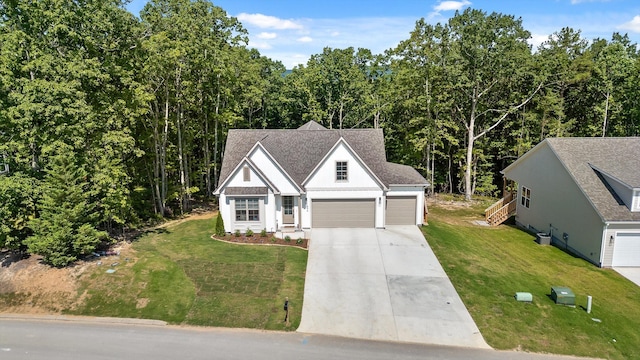 596 Nature Trl, Soddy Daisy, TN 37379 - view of front facade featuring concrete driveway, a front yard, a garage, and roof with shingles