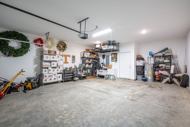8520 Kensley Ln, Hixson, TN 37343 - garage featuring electric water heater, a garage door opener, and a workshop area