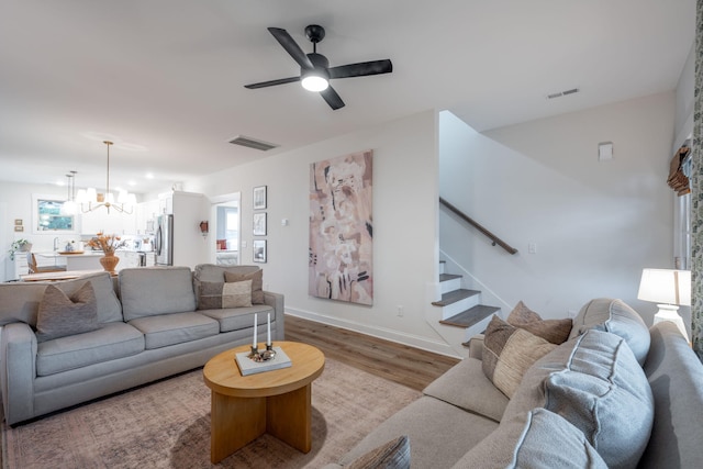 8520 Kensley Ln, Hixson, TN 37343 - living room with a chandelier, wood finished floors, plenty of natural light, and stairs
