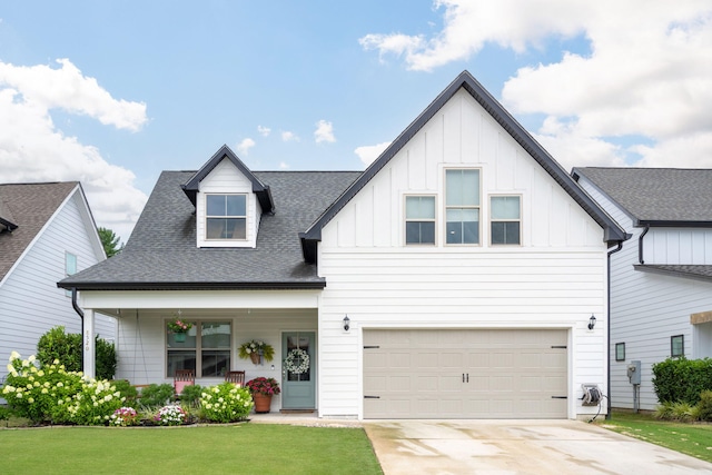 8520 Kensley Ln, Hixson, TN 37343 - modern farmhouse style home with board and batten siding, a front lawn, driveway, an attached garage, and roof with shingles