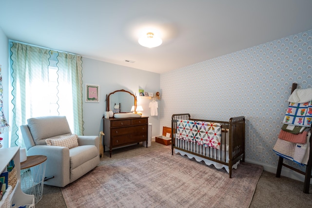 8520 Kensley Ln, Hixson, TN 37343 - bedroom with wallpapered walls, carpet floors, and a nursery area