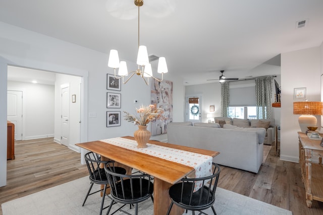 8520 Kensley Ln, Hixson, TN 37343 - dining room featuring light wood finished floors, ceiling fan, and a chandelier