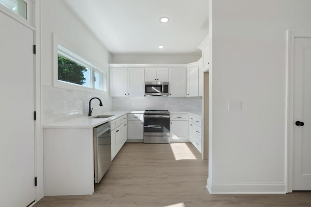 1310 Top St, Chattanooga, TN 37408 - kitchen with stainless steel appliances, decorative backsplash, recessed lighting, light countertops, and light wood-style floors