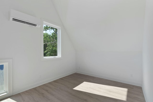 1310 Top St, Chattanooga, TN 37408 - spare room featuring a wall mounted AC, wood finished floors, and vaulted ceiling