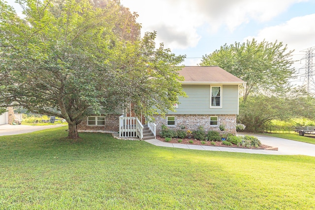 6134 Blue Ash Dr, Ooltewah, TN 37363 - view of front facade featuring a front lawn, brick siding, and driveway