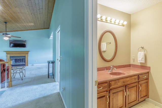 6134 Blue Ash Dr, Ooltewah, TN 37363 - bathroom featuring vanity, a ceiling fan, and a glass covered fireplace
