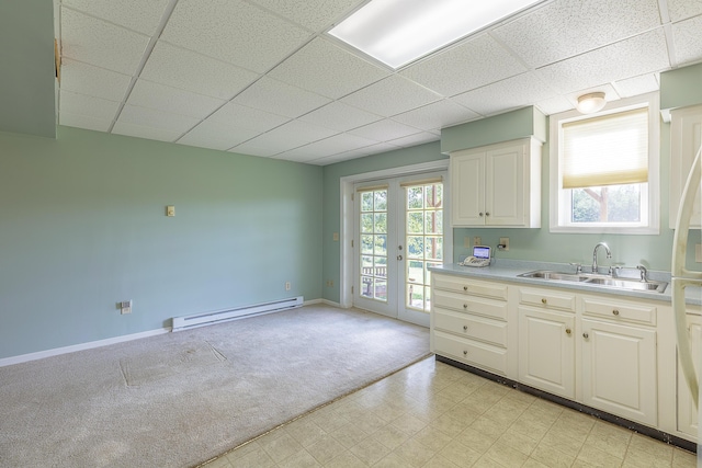 6134 Blue Ash Dr, Ooltewah, TN 37363 - kitchen with a baseboard heating unit, a paneled ceiling, light flooring, light countertops, and french doors