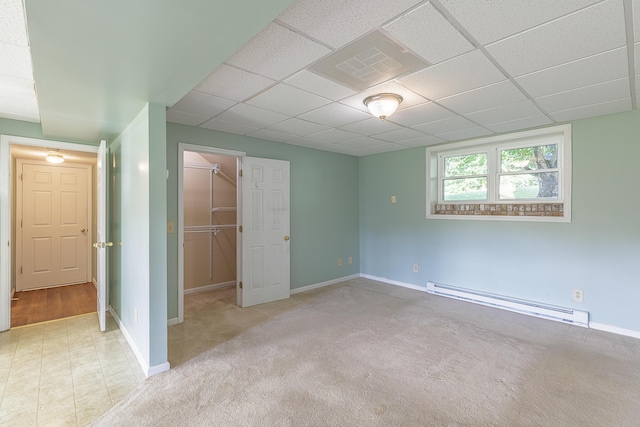 6134 Blue Ash Dr, Ooltewah, TN 37363 - unfurnished bedroom with a baseboard heating unit, a spacious closet, and a paneled ceiling
