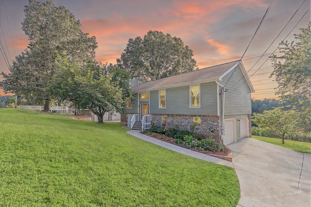 6134 Blue Ash Dr, Ooltewah, TN 37363 - bi-level home with concrete driveway, an attached garage, a front lawn, and a chimney