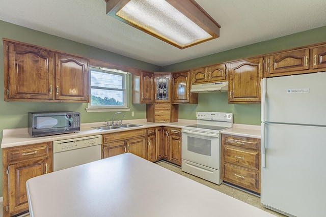 6134 Blue Ash Dr, Ooltewah, TN 37363 - kitchen featuring white appliances, under cabinet range hood, brown cabinetry, and light countertops