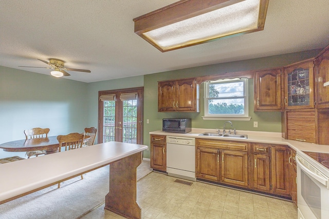 6134 Blue Ash Dr, Ooltewah, TN 37363 - kitchen featuring white appliances, brown cabinets, a textured ceiling, a ceiling fan, and light countertops