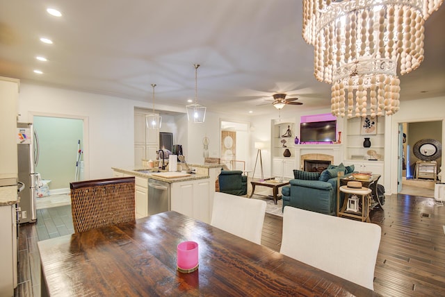 5215 Austin Rd, Hixson, TN 37343 - dining area featuring recessed lighting, a tiled fireplace, a ceiling fan, and dark wood-style floors
