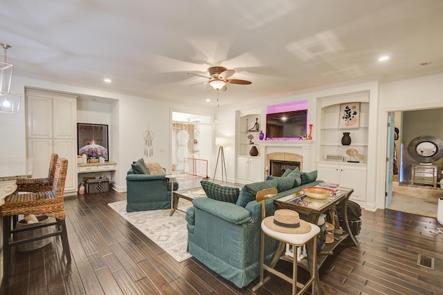 5215 Austin Rd, Hixson, TN 37343 - living area with a ceiling fan, a tile fireplace, dark wood-style flooring, recessed lighting, and ornamental molding