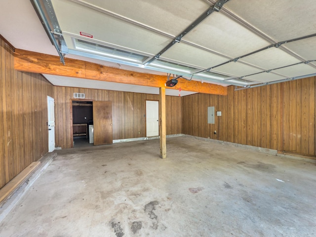 6515 Lake Shadows Cir, Hixson, TN 37343 - garage featuring wood walls and a garage door opener