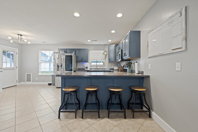 90 Quail Run, Lafayette, GA 30728 - kitchen featuring stainless steel appliances, recessed lighting, a peninsula, light tile patterned floors, and a kitchen breakfast bar