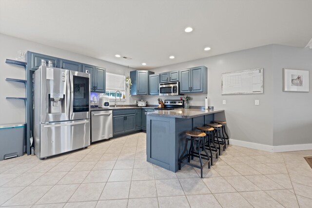 90 Quail Run, Lafayette, GA 30728 - kitchen featuring appliances with stainless steel finishes, a peninsula, a kitchen breakfast bar, light tile patterned floors, and recessed lighting