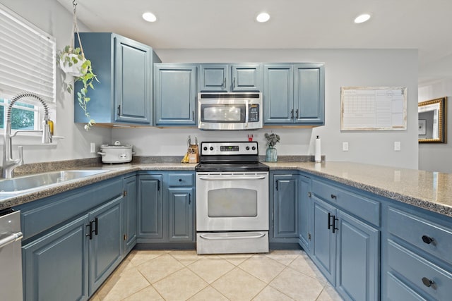90 Quail Run, Lafayette, GA 30728 - kitchen featuring appliances with stainless steel finishes, blue cabinets, light tile patterned flooring, and recessed lighting