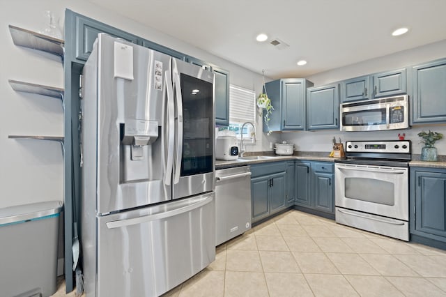 90 Quail Run, Lafayette, GA 30728 - kitchen featuring stainless steel appliances, blue cabinets, light tile patterned floors, and recessed lighting