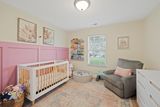 90 Quail Run, Lafayette, GA 30728 - bedroom with a crib, a wainscoted wall, and a decorative wall