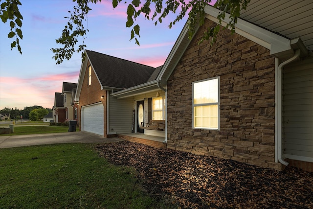 90 Quail Run, Lafayette, GA 30728 - view of side of home with stone siding, concrete driveway, a garage, and a yard