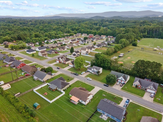 90 Quail Run, Lafayette, GA 30728 - aerial perspective of suburban area with a mountainous background and a heavily wooded area