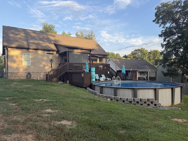 7566 Grasshopper Rd, Georgetown, TN 37336 - back of house with a deck, stairway, a lawn, an outdoor pool, and a shingled roof