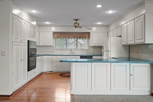 4128 Hamill Rd, Hixson, TN 37343 - kitchen with freestanding refrigerator, a peninsula, ceiling fan, white cabinetry, and light wood-style flooring