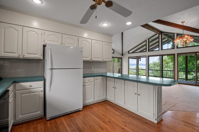 4128 Hamill Rd, Hixson, TN 37343 - kitchen with freestanding refrigerator, a peninsula, healthy amount of natural light, dishwasher, and a textured ceiling