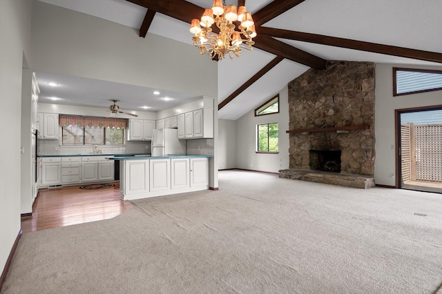 4128 Hamill Rd, Hixson, TN 37343 - kitchen with freestanding refrigerator, light colored carpet, open floor plan, a chandelier, and beam ceiling