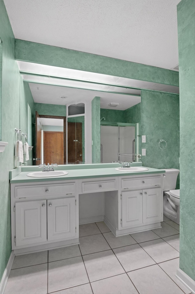 4128 Hamill Rd, Hixson, TN 37343 - bathroom featuring double vanity, tile patterned floors, a stall shower, and a textured ceiling