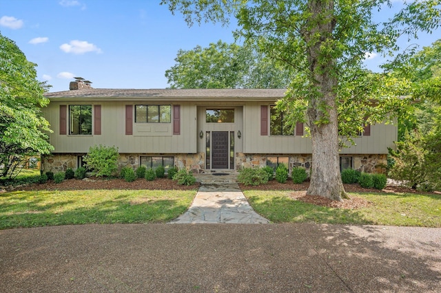 4128 Hamill Rd, Hixson, TN 37343 - split foyer home with a chimney, stone siding, and a front yard
