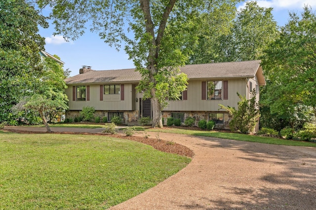 4128 Hamill Rd, Hixson, TN 37343 - raised ranch featuring a chimney, a front lawn, curved driveway, and stone siding