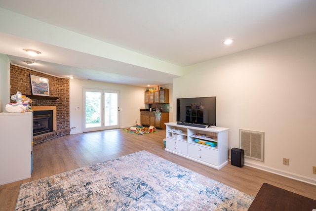1107 Copperwood Dr, Hixson, TN 37343 - living area with wood finished floors, a brick fireplace, and recessed lighting