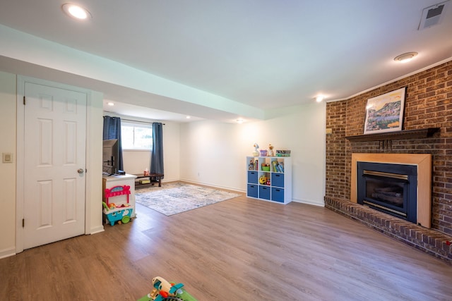 1107 Copperwood Dr, Hixson, TN 37343 - playroom with wood finished floors, a fireplace, and recessed lighting