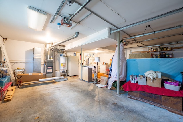 1107 Copperwood Dr, Hixson, TN 37343 - garage with freestanding refrigerator, water heater, and a garage door opener