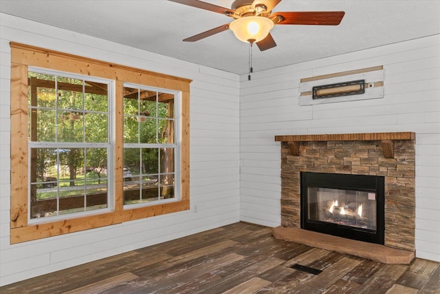 1483 Resaca Lafayette Rd NW, Resaca, GA 30735 - unfurnished living room with dark wood finished floors, a fireplace, a ceiling fan, and wood walls
