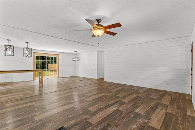 1483 Resaca Lafayette Rd NW, Resaca, GA 30735 - unfurnished living room with a textured ceiling, wood finished floors, ceiling fan, and brick wall