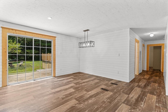 1483 Resaca Lafayette Rd NW, Resaca, GA 30735 - unfurnished dining area with hardwood / wood-style floors, a textured ceiling, a chandelier, and wooden walls