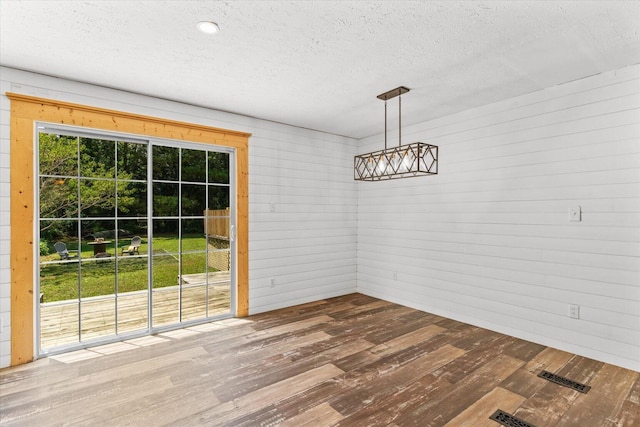 1483 Resaca Lafayette Rd NW, Resaca, GA 30735 - unfurnished dining area with hardwood / wood-style flooring, a textured ceiling, and wood walls