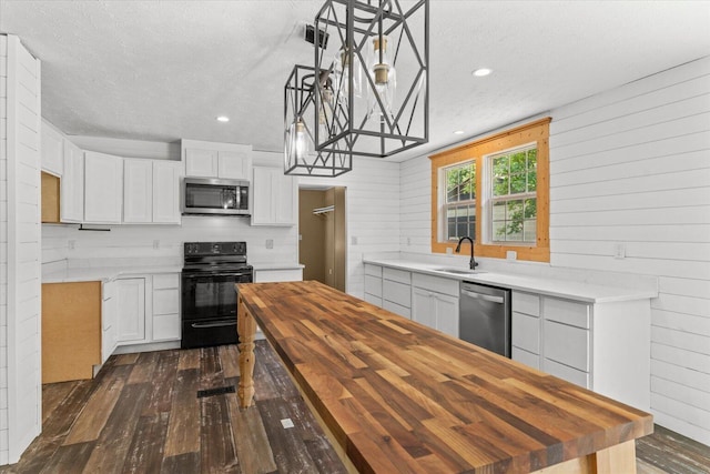 1483 Resaca Lafayette Rd NW, Resaca, GA 30735 - kitchen with stainless steel appliances, wooden counters, dark wood-style floors, a textured ceiling, and white cabinets